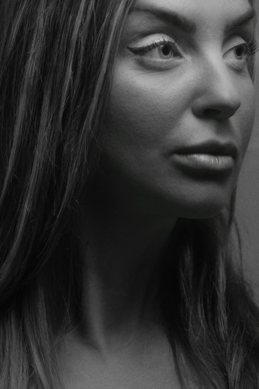 a woman with long hair and large eyes stares at soing