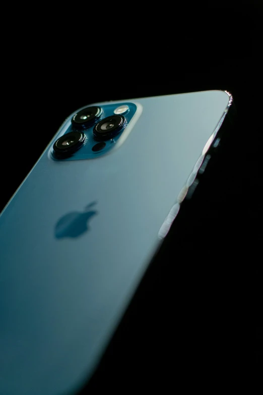 an apple phone that has its front camera and a lens