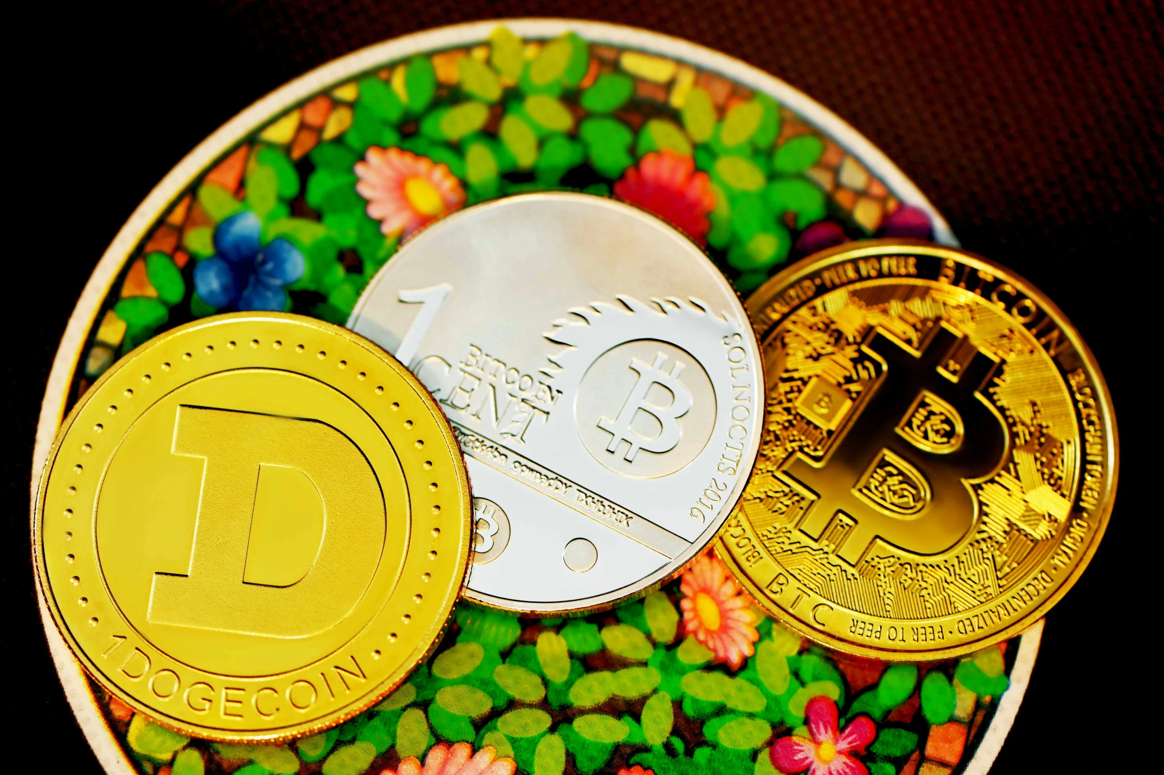 three bitcoins on a round plate with leaves