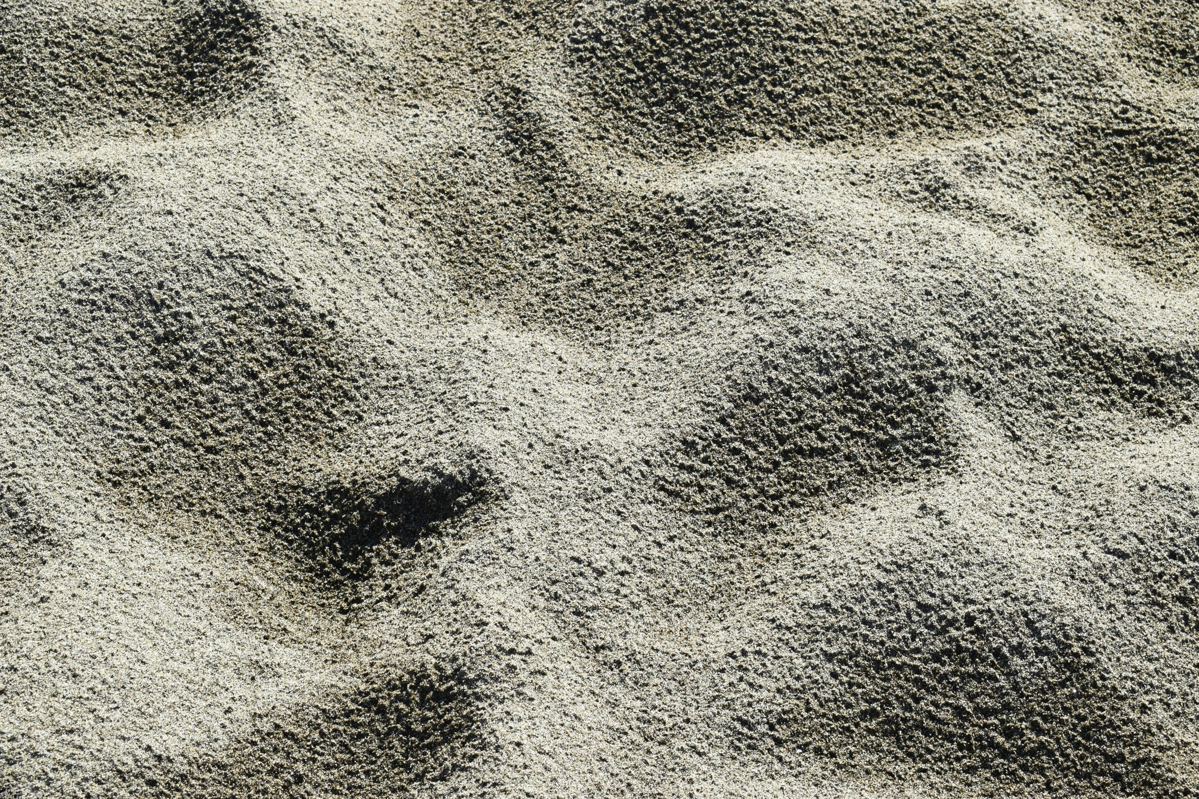 a gray object floating on top of a white and black surface