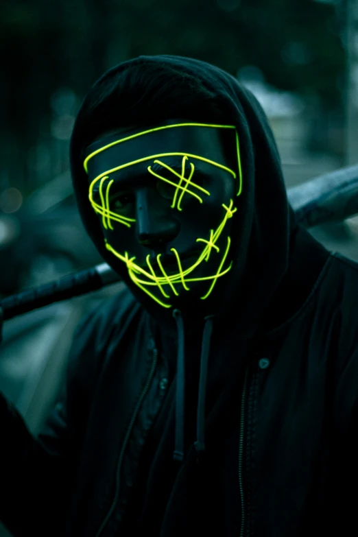 a person with a glowing mask in the dark