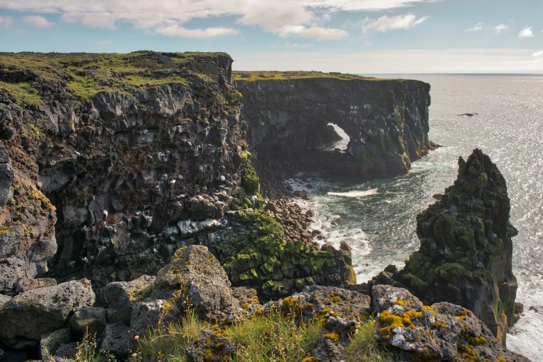 a cliff face with a sea and the cliffs are mostly submerged in water