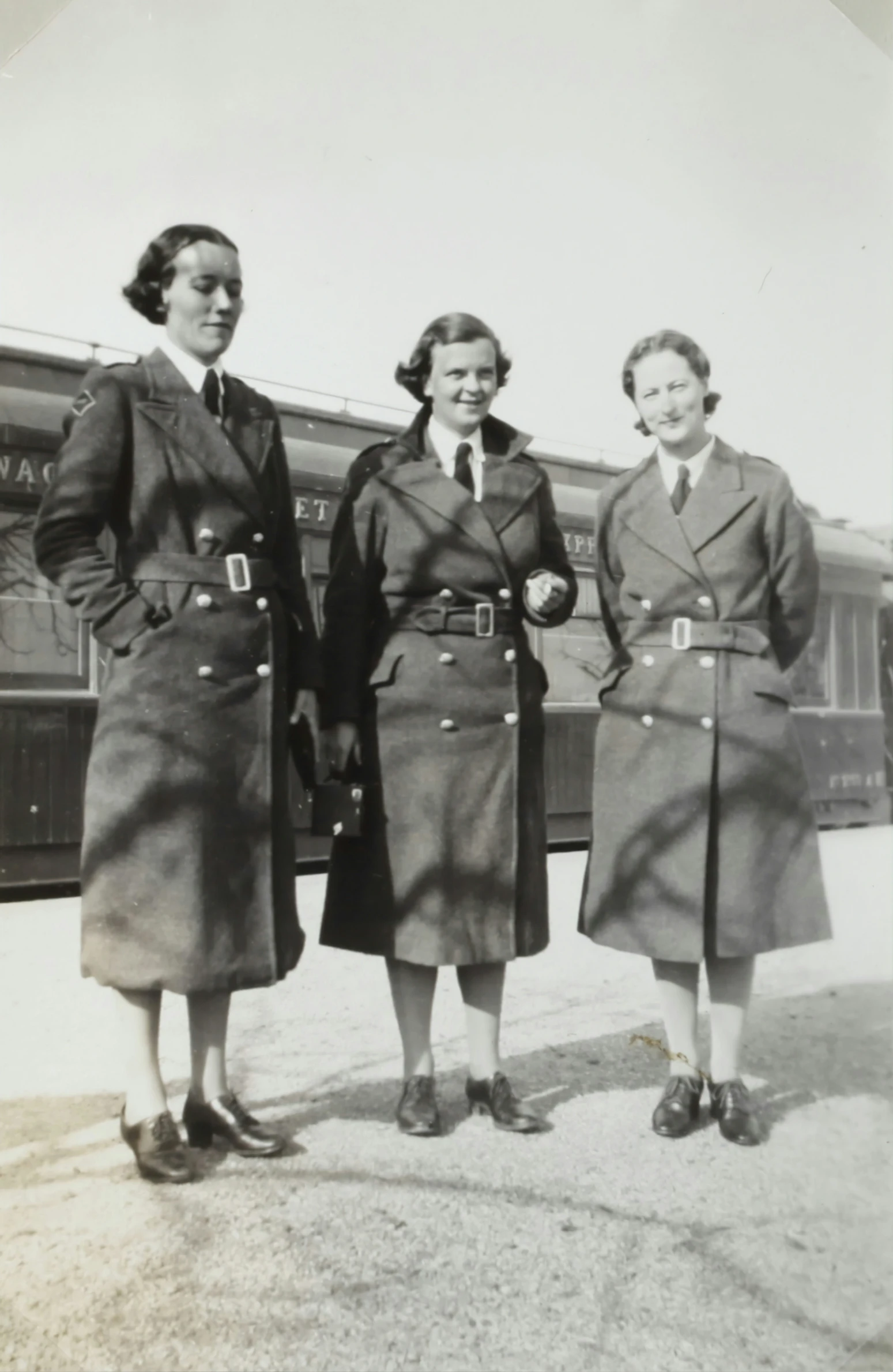 an old picture shows two women in uniforms posing for a po