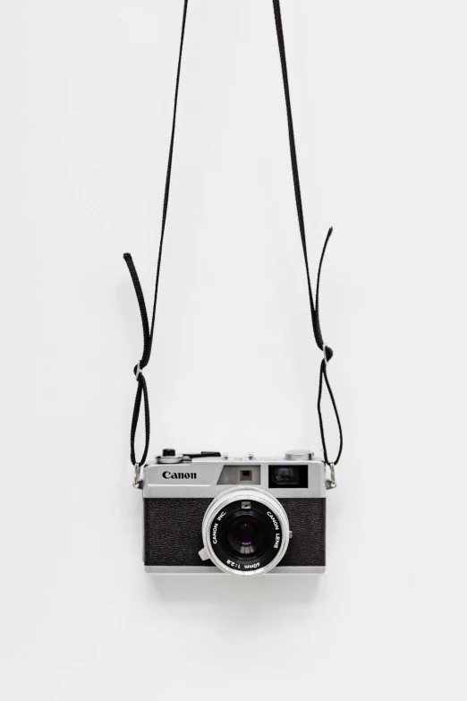 an old po camera hanging on a leather strap