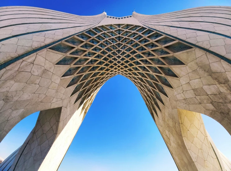 a tall architectural structure with pillars at the top