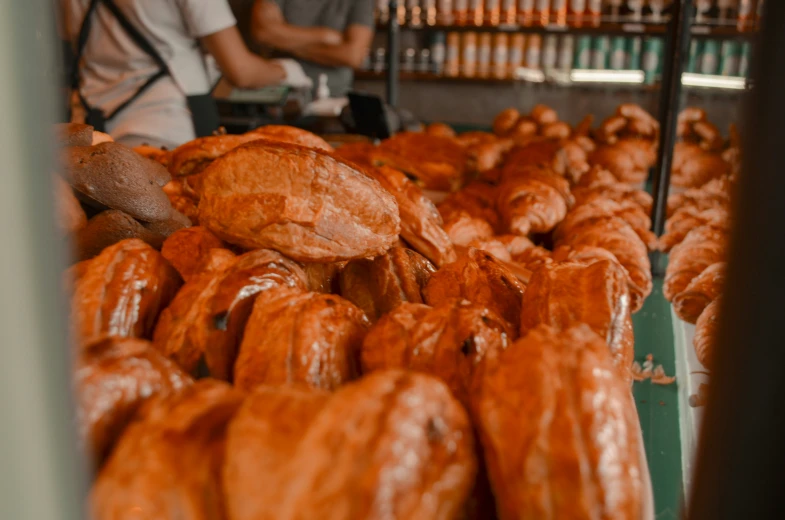 a store with several trays of donuts that are glazed and ready to be made