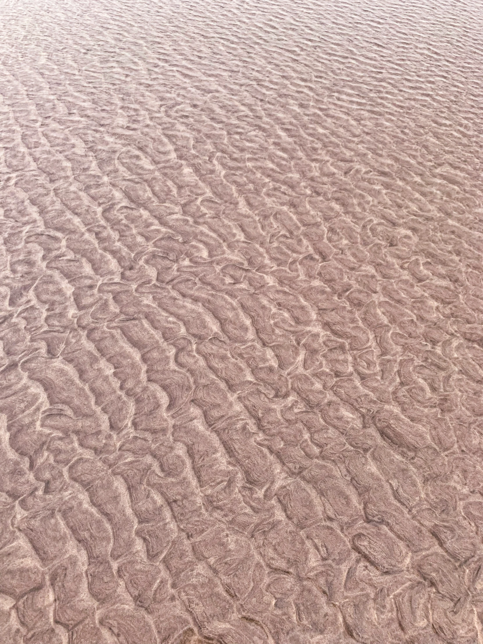 this is a small area of sand with white and gray patterns