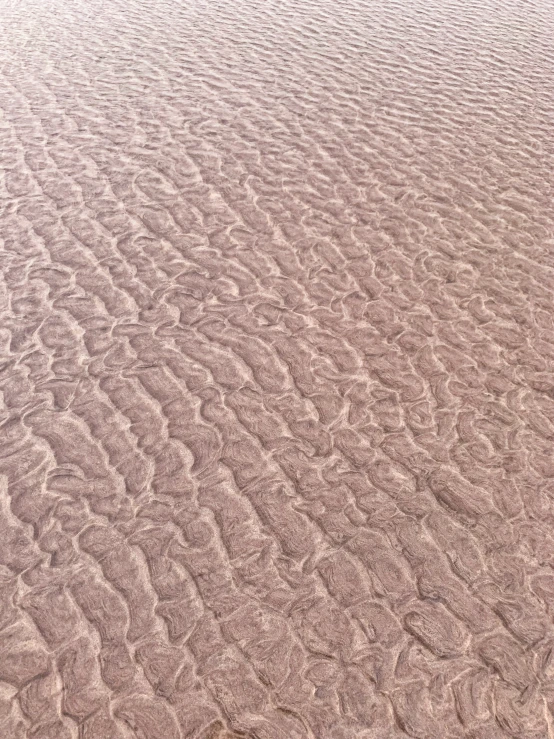 this is a small area of sand with white and gray patterns