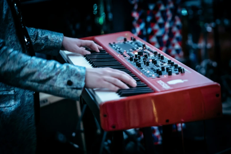 a person that is playing a small electronic keyboard