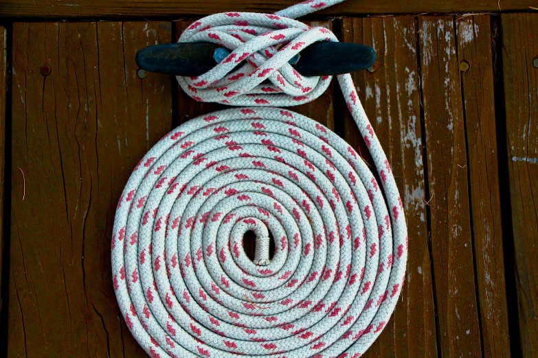 a white and red rope on wooden boards