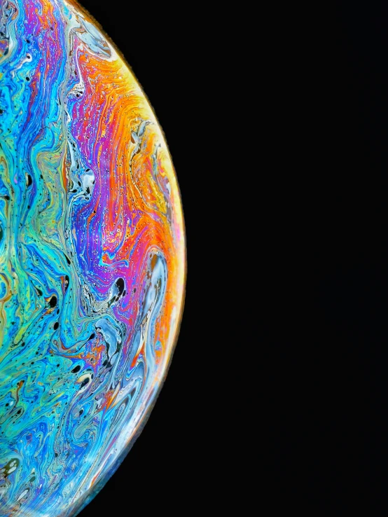 the planet has an unusual and colorful liquid painting effect