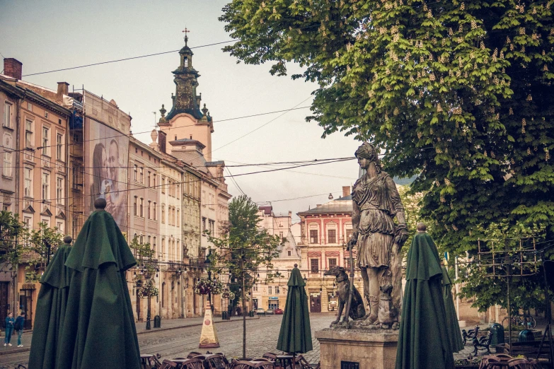 this is an empty city square with green umbrellas