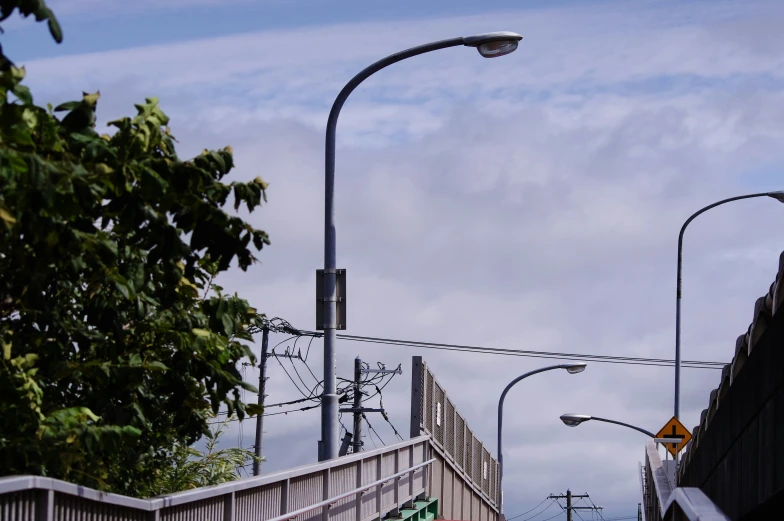 two street lamps and a pedestrian walk over bridge