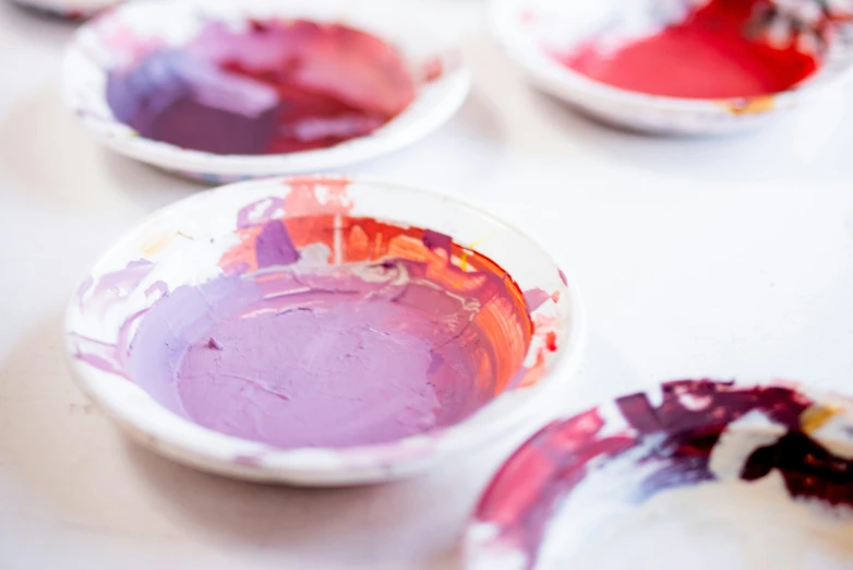 a collection of bowls filled with different colors