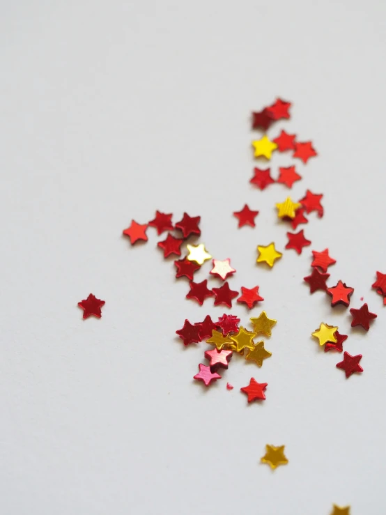 colorful stars scattered about the ground on white background
