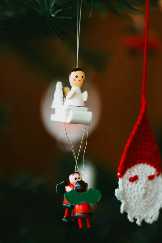 two ornaments that are hanging from a tree