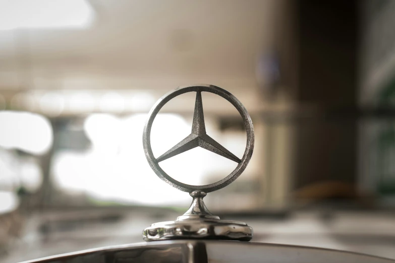 a mercedes logo with an interesting silver finish