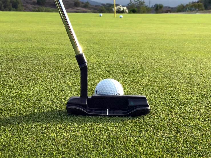 a golf ball and tee on the ground