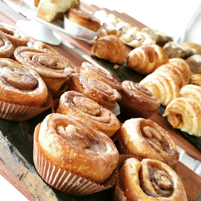 a display table topped with cupcakes and rolls