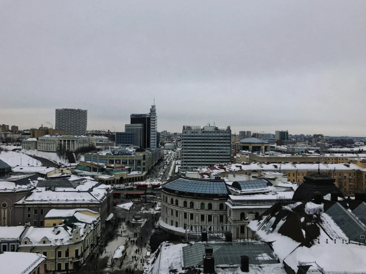 a snow covered view of a cityscape with buildings
