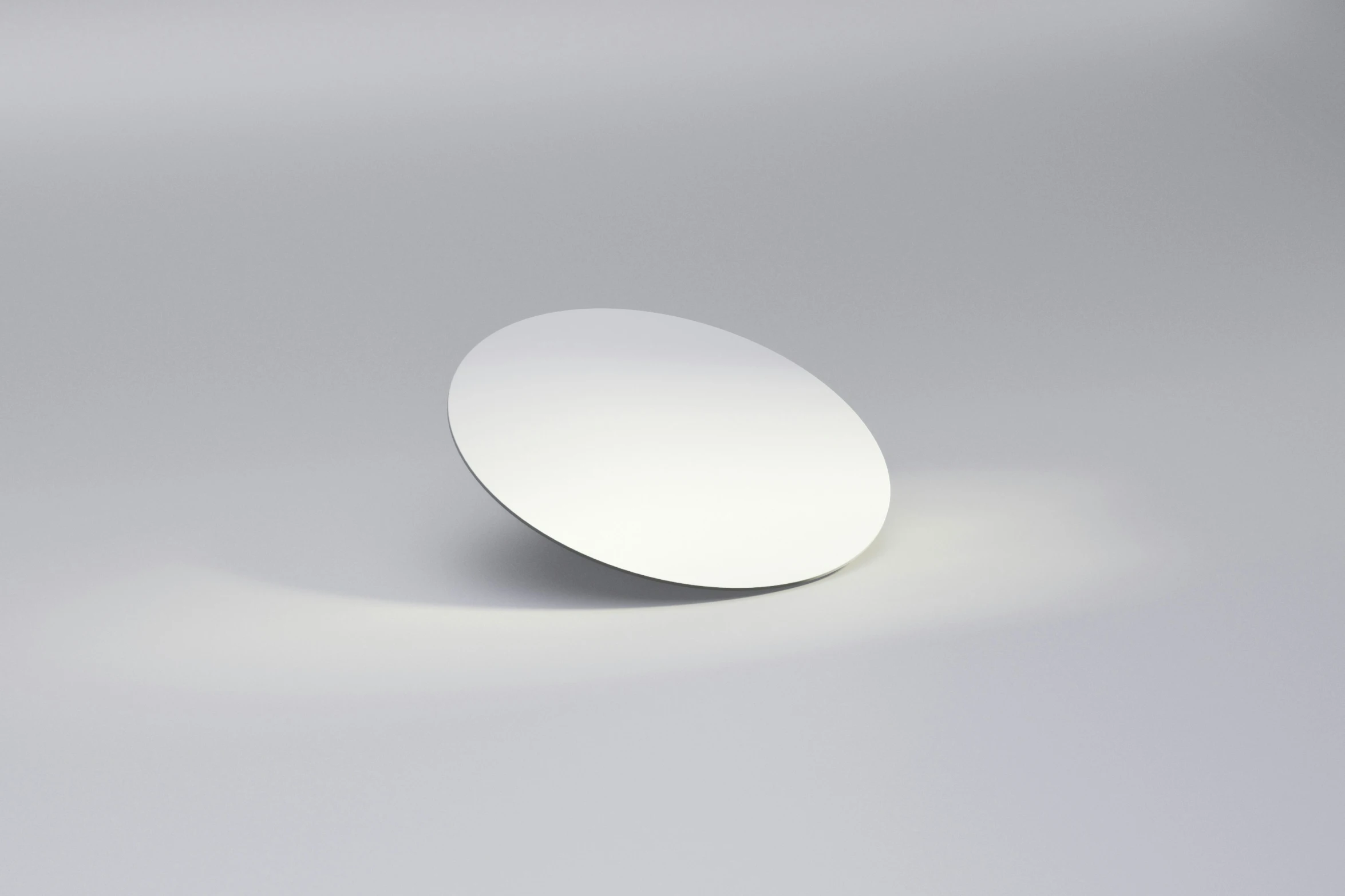 a white round plate on a light grey surface