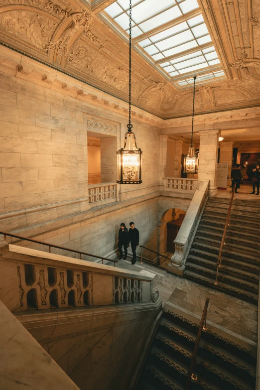 the three people stand on the steps inside a building