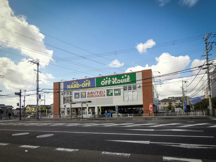 a building with electrical wires behind it next to a street