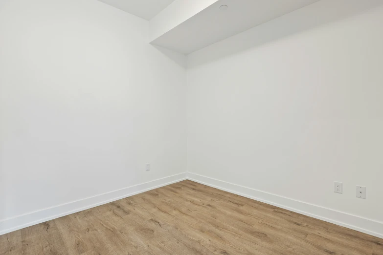 empty white room with wood floors and no one inside