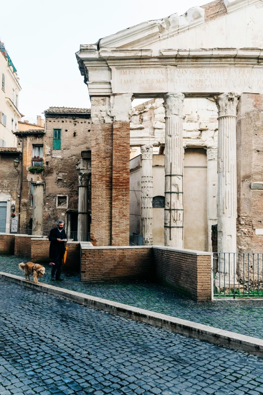 people standing outside an old building with bricks on the ground