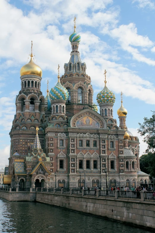 people are standing outside of a large building with towers