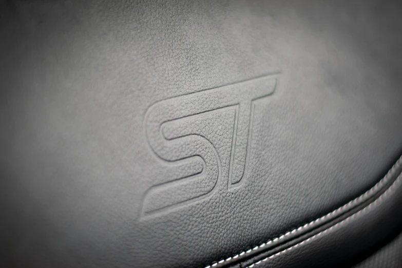 the back seat of a sports car with an automobile logo