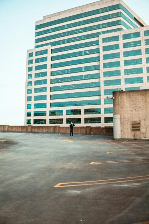 a person stands on a sidewalk next to a building