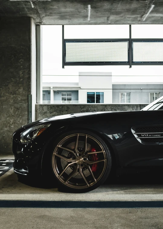 a black car is parked in front of an overhang