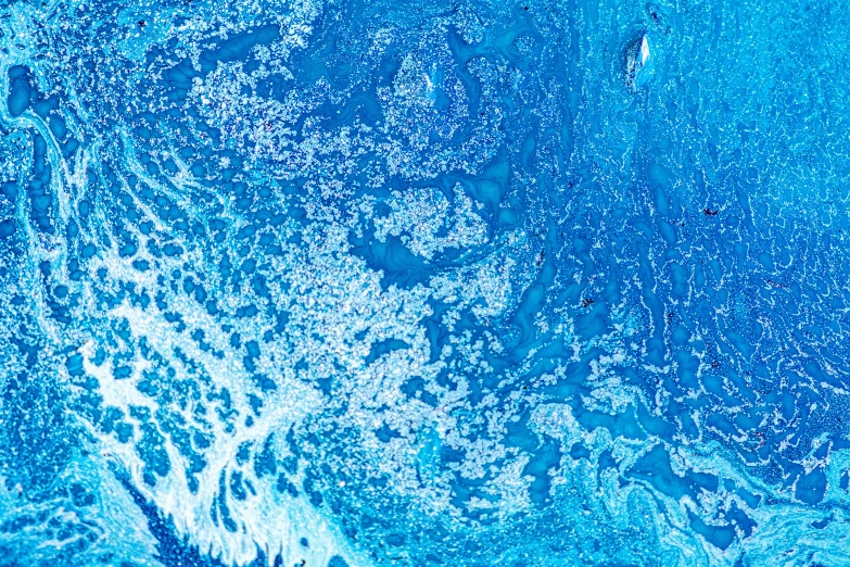 a wave hitting the surface of a deep blue ocean