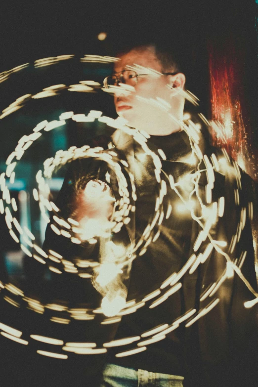 a guy is making some big rings of lights