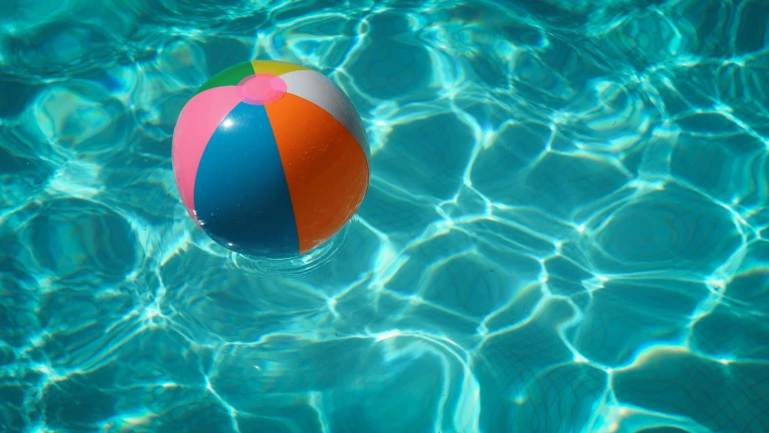 an inflatable beach ball floats in a pool