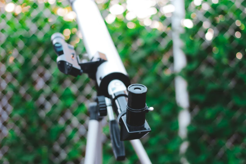 the view of a black and white camera from below a telescope