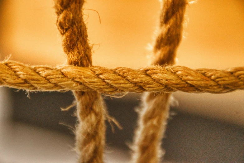 a brown cord on a chair with a golden wall in the background