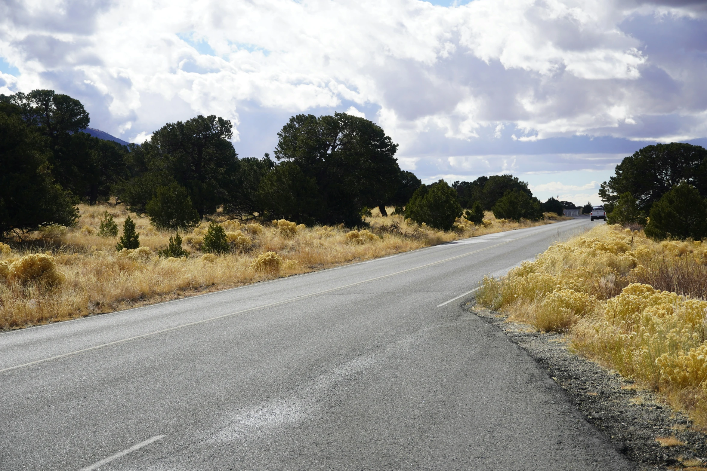 a view from the side of the road looking down at an empty street