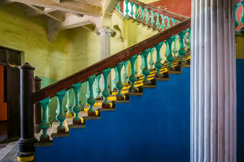 a fancy stair case in a blue walled building