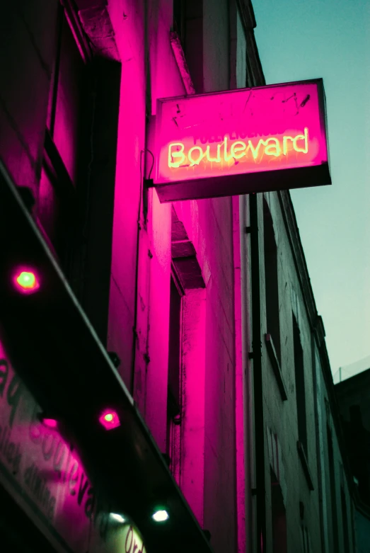 a neon sign saying boulevard on the side of a building