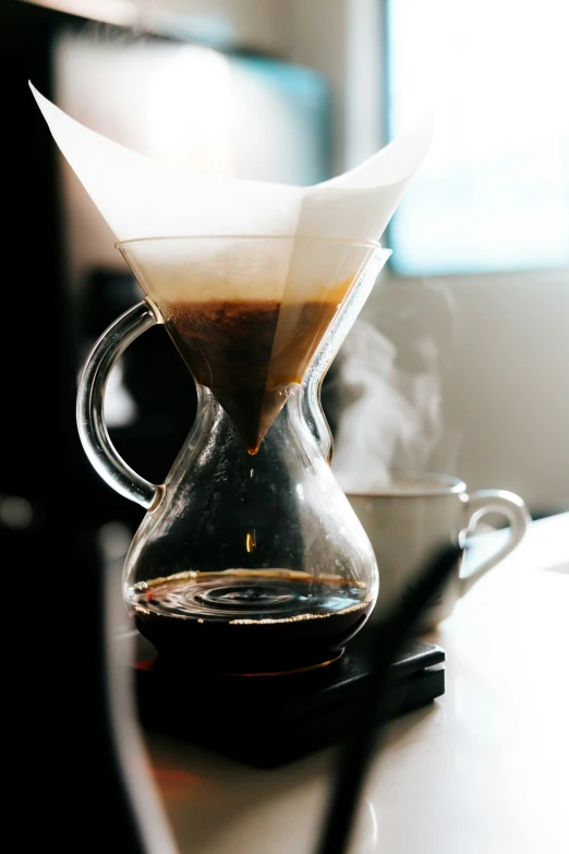 a coffee pot with smoke coming out of it sitting on a counter