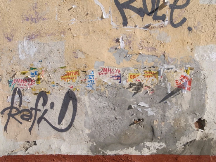 a wall covered with many stickers and graffiti