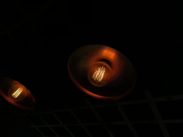 two light lamps that are glowing in the dark