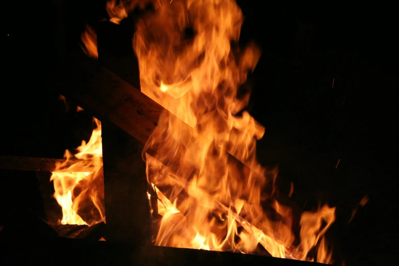there are many pieces of burning wood on fire