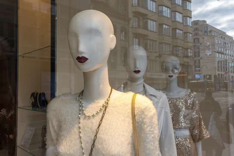 mannequins dressed in different styles and sizes with necklaces on