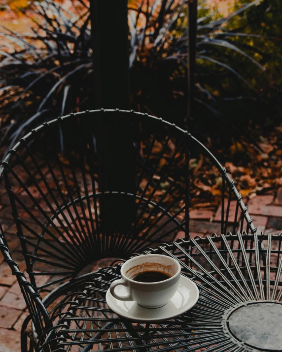 a coffee cup sits on an ornate table