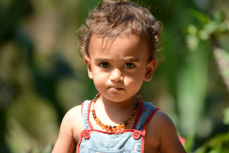 a little girl is wearing a red and blue shirt