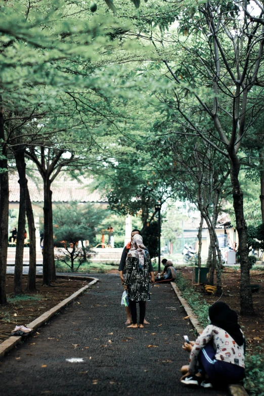 a group of people on some sidewalks and some trees