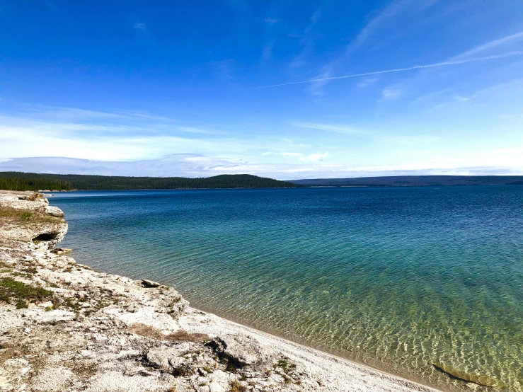 a blue and clear ocean and shore line